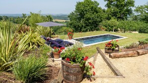 A pool surrounded by a garden with plants and a view of the countryside. - L'Atelier de Scarlett – An Intimate Luxury Escape in the Heart of Gascony (Unknown)