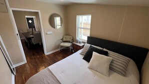 A bedroom with a large bed, a desk, a chair, and a window. - Sturgis Rally perfect location! (Sturgis)