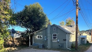 A single-story house with a garage, a small front yard, and a dirt driveway. - Sturgis Rally perfect location! (Sturgis)