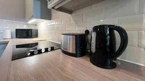 Een koffiezetapparaat/waterkoker, een koelkast, een microgolfoven