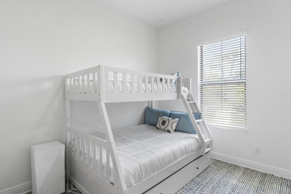 A bunk bed with a ladder, a window with blinds, and a patterned floor. - 1 Mile to Beach! | Heated Pool | New Construction (Naples)
