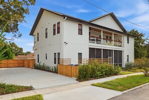 A two-story house with a garage, a fenced backyard, and a well-maintained lawn.