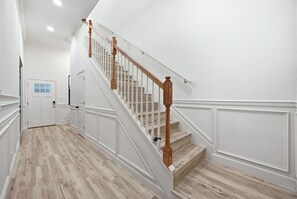 A staircase with wooden balusters and a light-colored wooden floor.