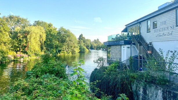 A riverside view with a building labeled "The Boathouse at Boaters Lock."