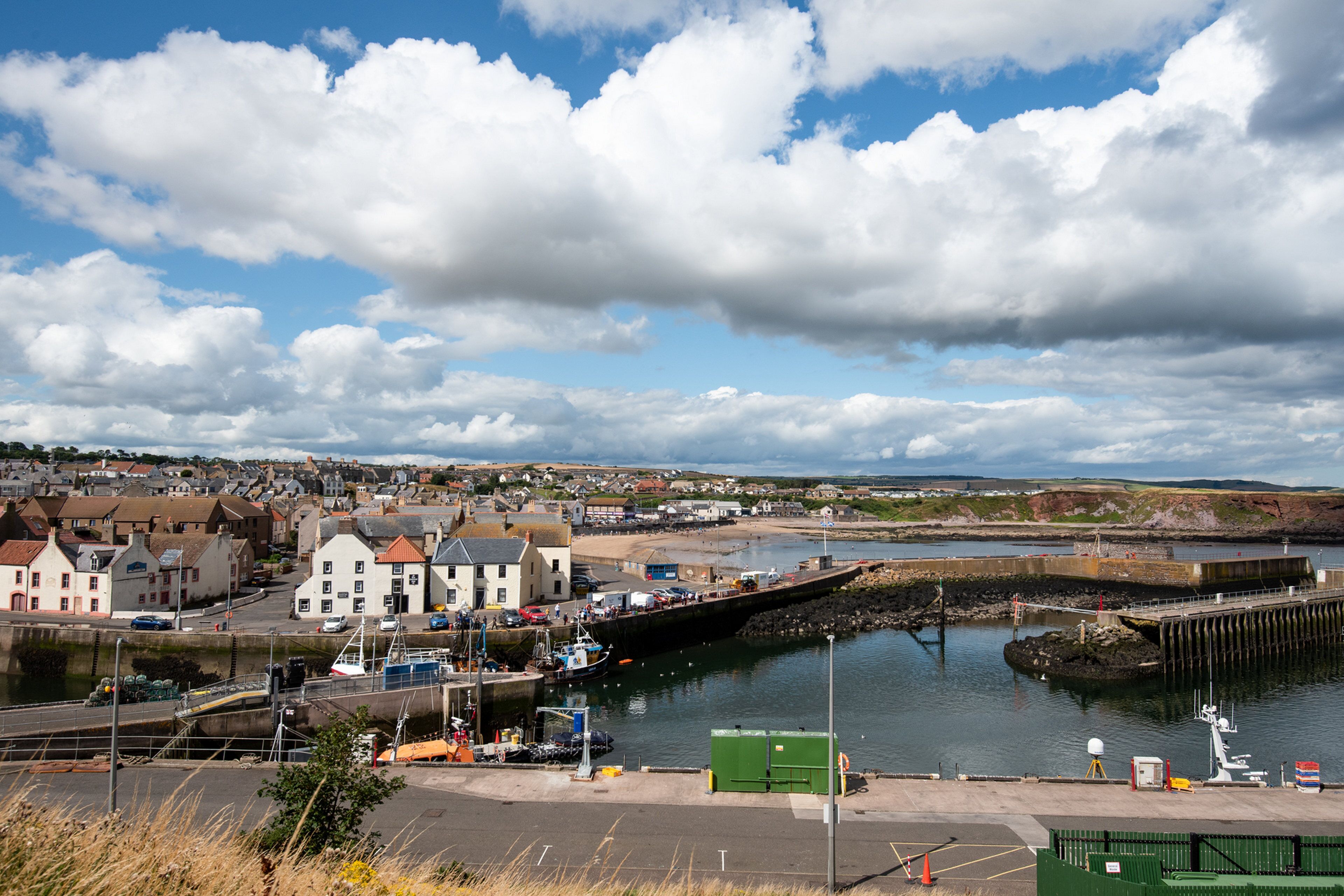 A coastal town with a harbor, boats, and a bridge.