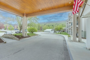 A gas station with a covered area, a parking lot, and a building with columns. - Riverside Penthouse Condo (Lincoln)