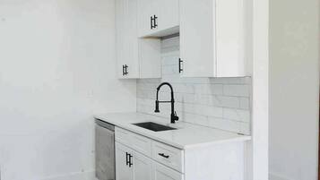 Coffee/tea maker, fridge, cookware/dishes/utensils