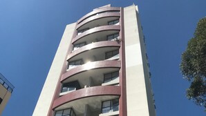 A multi-story building with a modern architectural design, featuring balconies and large windows. - Entire Apartment - Duplex in Panamby (Vila Andrade São Paulo)