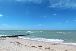 A beach with clear skies and calm waters.