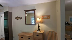 A room with a wooden dresser, a chair, a mirror, and a lamp. - Perfect home base for all things "Redwoods"! Space to park boat. Dog friendly. (Klamath)