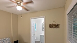 A bedroom with a bed, a ceiling fan, a window with blinds, and a door leading to a bathroom. - Perfect home base for all things "Redwoods"! Space to park boat. Dog friendly. (Klamath)
