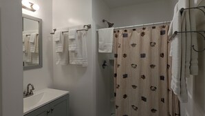 A bathroom with a white sink, mirror, and towel rack. - Perfect home base for all things "Redwoods"! Space to park boat. Dog friendly. (Klamath)