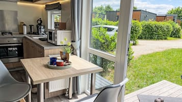 Een koelkast, een magnetron, een oven, kookgerei, borden en bestek