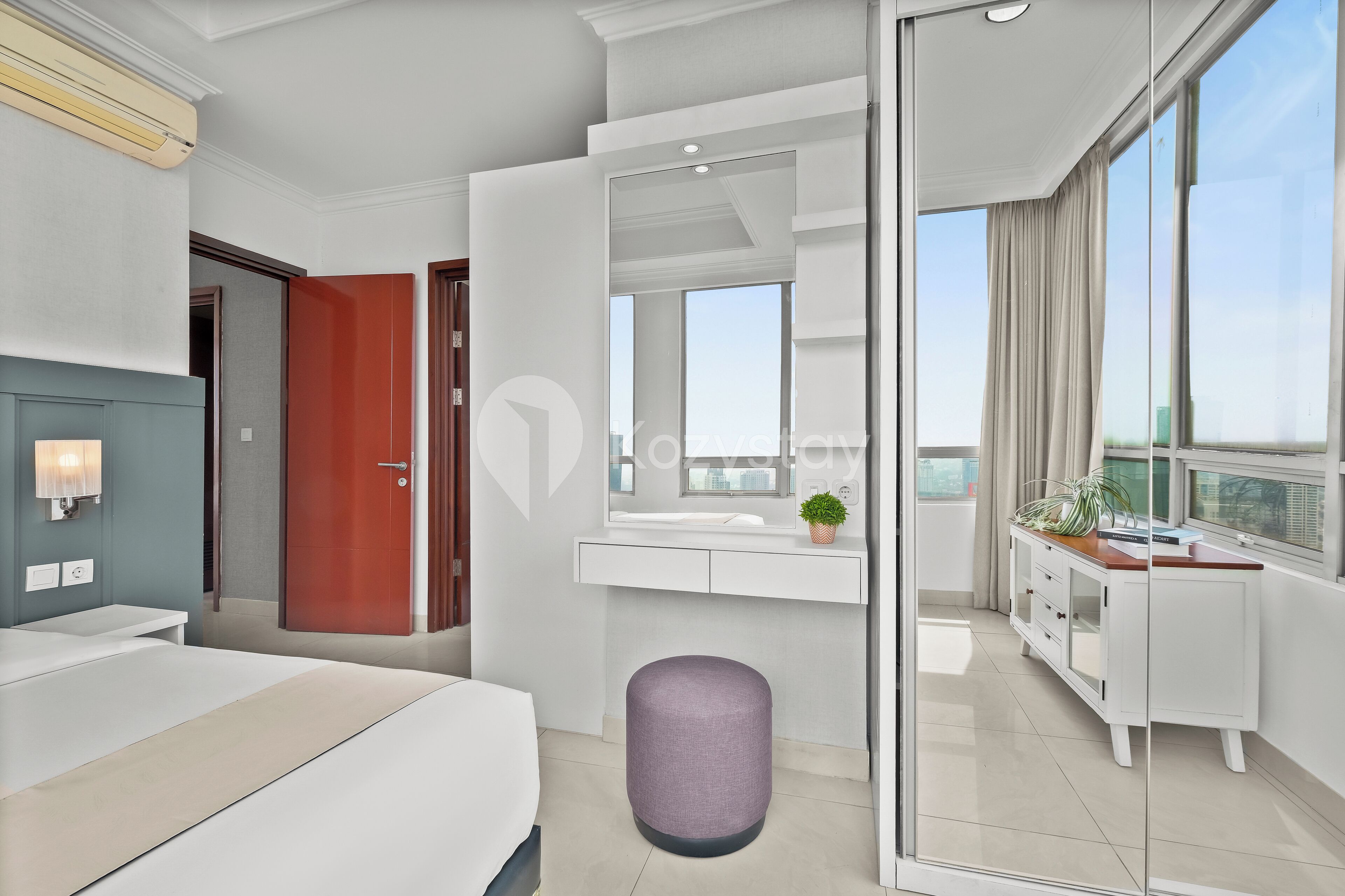 A modern hotel room with a bed, a bathroom, a large window, and a balcony.