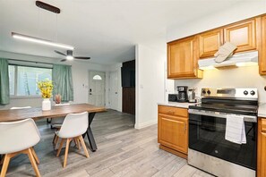 Fridge, toaster, cookware/dishes/utensils, dining tables