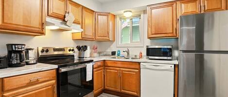 Fridge, toaster, cookware/dishes/utensils, dining tables