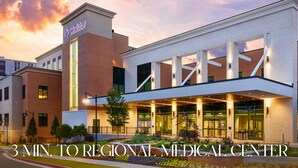 A medical center with a prominent Wellstar sign, a covered entrance, and a landscaped area in front. - Stylish 3BR Near Dining, Parks & Shops (Marietta)