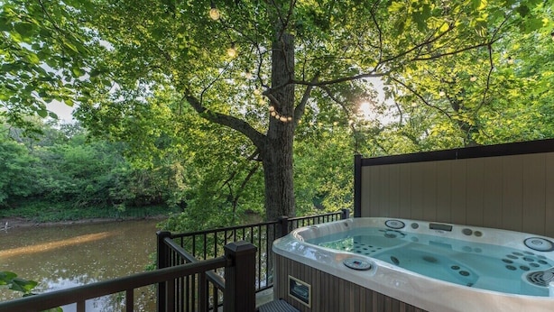 A hot tub on a wooden deck with a view of a river and trees. - Southern Ohio Retreat w/ Private Hot Tub (Georgetown)