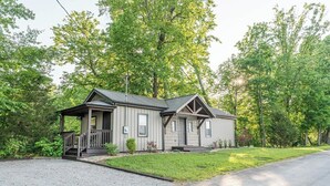 A two-story house with a porch, a garage, and a driveway. - Southern Ohio Retreat w/ Private Hot Tub (Georgetown)