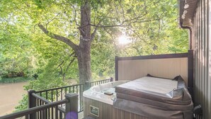 A hot tub on a balcony with a view of a river and trees. - Southern Ohio Retreat w/ Private Hot Tub (Georgetown)