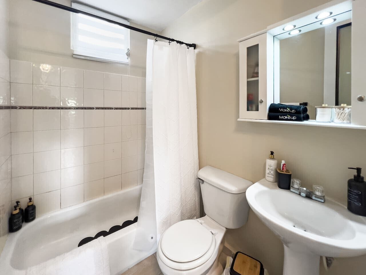 A bathroom with a bathtub, toilet, and sink.