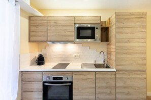 Fridge, coffee/tea maker, toaster, cookware/dishes/utensils