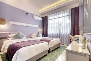 A hotel room with two beds, a desk, a chair, a window with curtains, an air conditioning unit, and a wall-mounted shelf. - Julan'an Homestay (Guilin Liangjiang Sihu Dongxi Alley Shop) (Guilin)