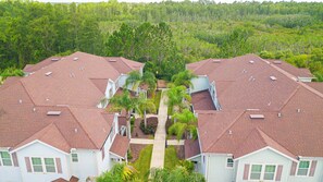 A residential area with multiple houses featuring red-tiled roofs and white exteriors. - Spacious 3-bedroom townhome in Kissimmee, perfect for family getaways! (Kissimmee)