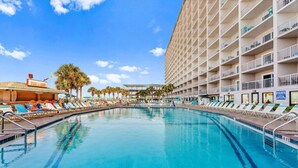 A swimming pool with lounge chairs, a bar, and a high-rise building with balconies. - Summit Gulf Front Unit 421 | 4th Floor (Panama City Beach)