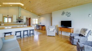 A spacious living area with a wooden ceiling, a kitchen with bar stools, a TV, and a comfortable seating area. - Fish, Hike & More! Home w/ Views in Stevensville (Stevensville)