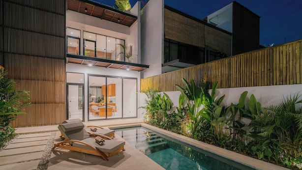 A modern house with a swimming pool, outdoor seating, and lush greenery. - 3-bedroom Aquamarine villa in awesome Bali with Private Pool (Bali)