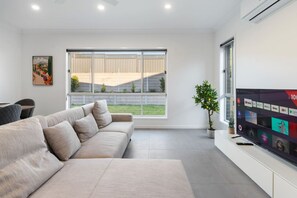 TV - Relax-Ready 4BR Near Bayside & Shops | Workspace (Victoria Point)