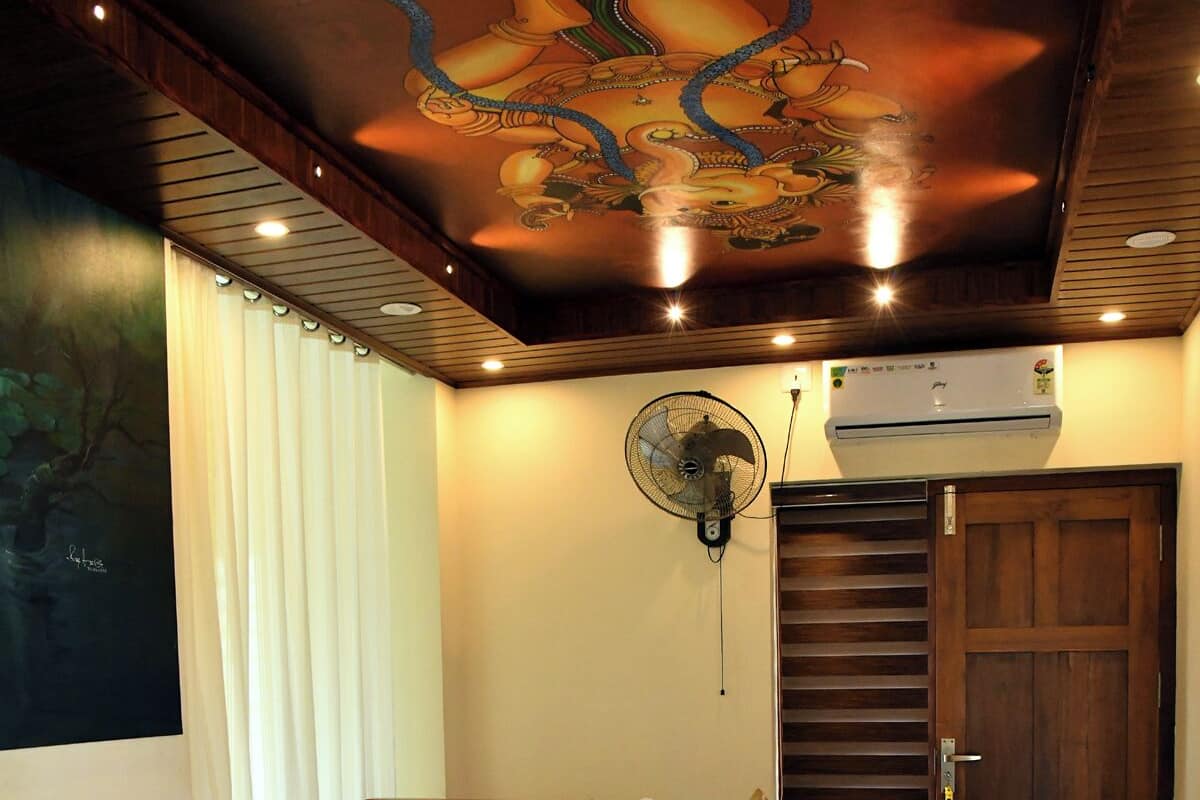 A hotel room with a wooden bed, white linens, and a ceiling mural.