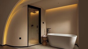 A modern bathroom with a freestanding bathtub, a shower, and a minimalist design. - Lijiang Garden vacation PuZhi hotel (Lijiang)