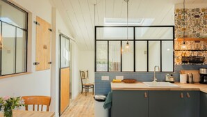 A modern kitchen with a large window, a built-in sink, and a coffee machine. - Charming studio in lovely Les Vans, National Park Monts d'Ardèche, river nearby. (Les Vans)