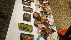 A long table with various dishes and flatbreads, likely a buffet or communal meal setting. - Savali Resort (Diveagar)