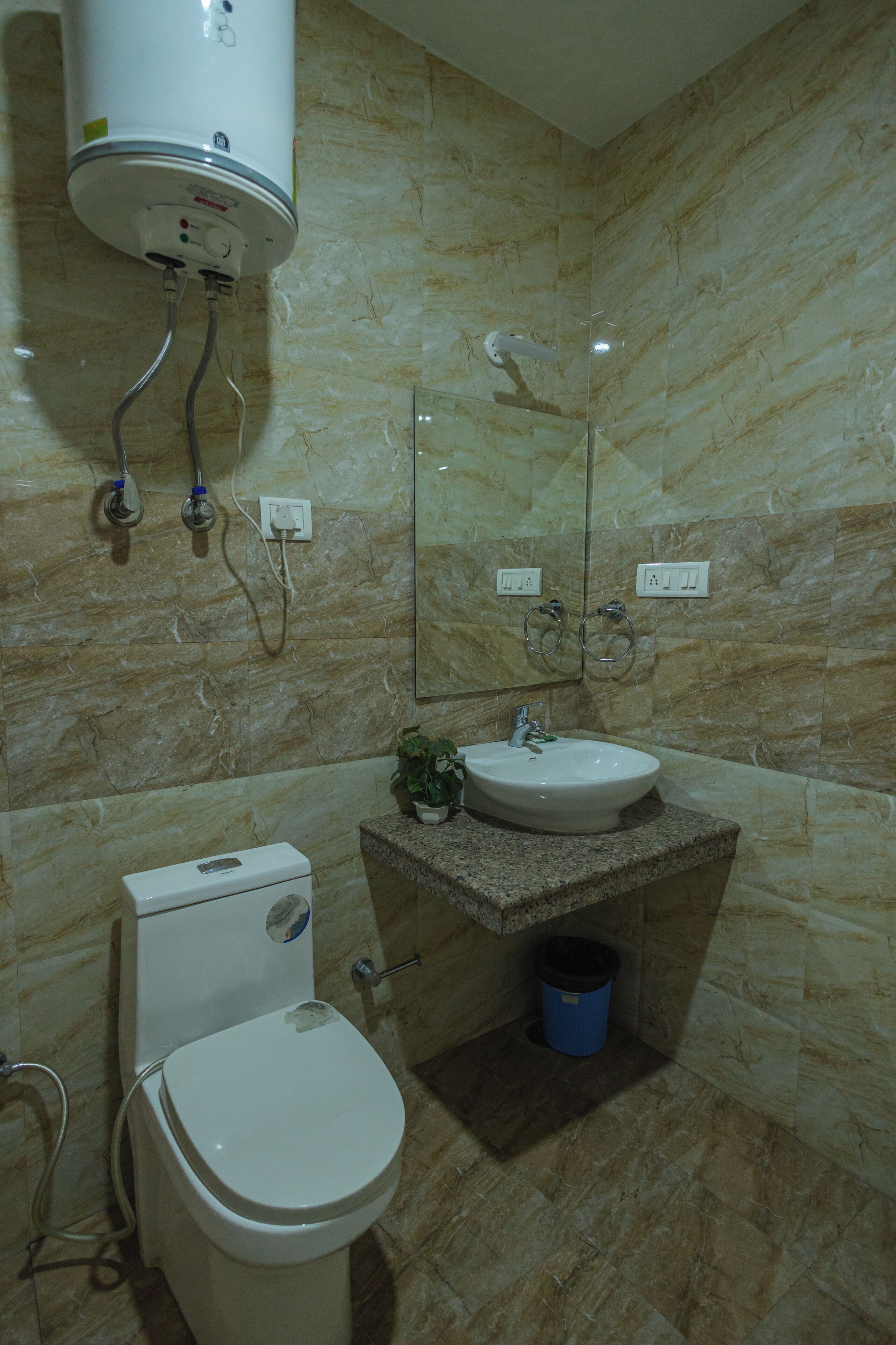 A bathroom with a toilet, sink, and shower.