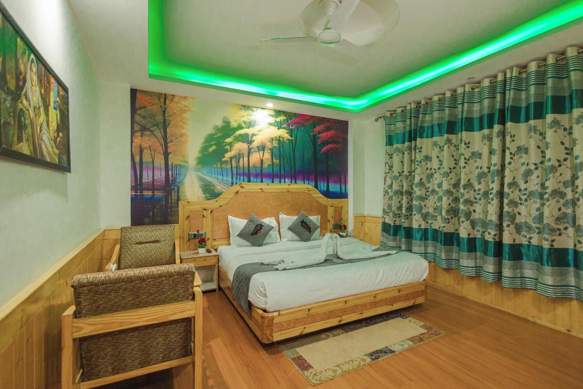A bedroom with a wooden bed, a nightstand, a chair, a painting of a forest, and curtains with a floral pattern.