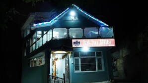 A two-story building with a sign reading "Jakhu Hills." - Jakhu heights (Shimla)