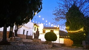 A traditional building with a tiled roof, surrounded by stone steps and a small tree. - Suitur rural House Cortijo de Don Manuel ( Grandparents) (Granada Algarinejo)