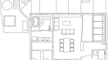 Plano de planta que muestra una zona de estar central, una cocina, un comedor y un baño.