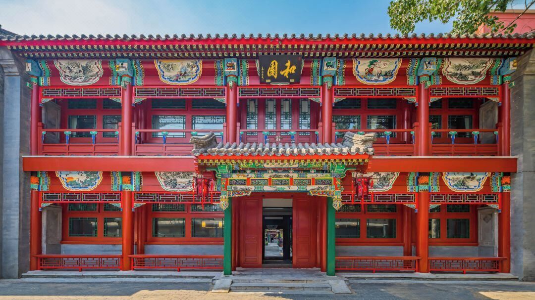 A traditional red building with ornate decorations and a tiled roof.
