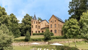 A large stone building with a swimming pool and lounge chairs. - Castell de Villavecchia - Castle with pool Girona Barcelona (Sant Hilari Sacalm)