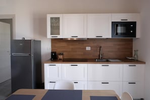 Fridge, microwave, stovetop, coffee/tea maker