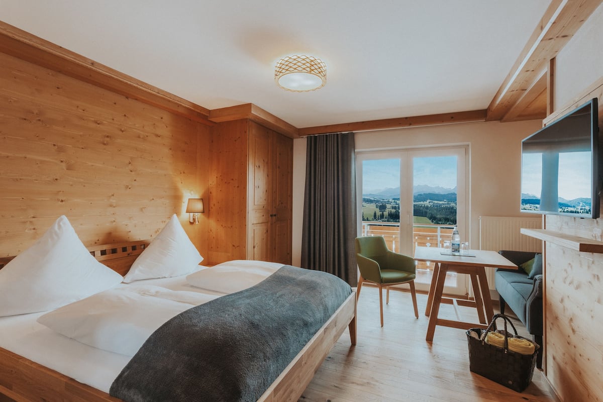 Een hotelkamer met een bed, een tafel, een stoel en een televisie.