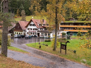 Un hotel con varias edificaciones, una zona de estacionamiento y un paisaje natural circundante.
