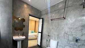 A modern bathroom with a white sink, toilet, and shower. - Homigo - PWTC (Kuala Lumpur)