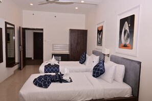 A hotel room with two beds, a wardrobe, a mirror, and artwork on the walls. - Comfort Inn Shubhra Ghazipur (Ghazipur)