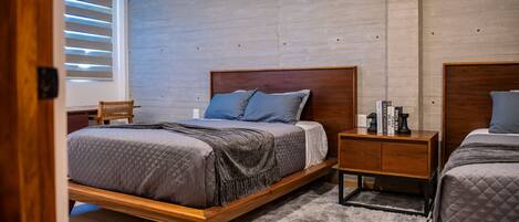 A bedroom with a wooden bed, a nightstand, a chair, and a bookshelf.
