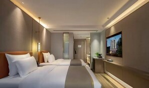 A modern hotel room with two beds, a flat-screen TV, a small desk, and a view of a building. - Weiru Hotel (Changsha)